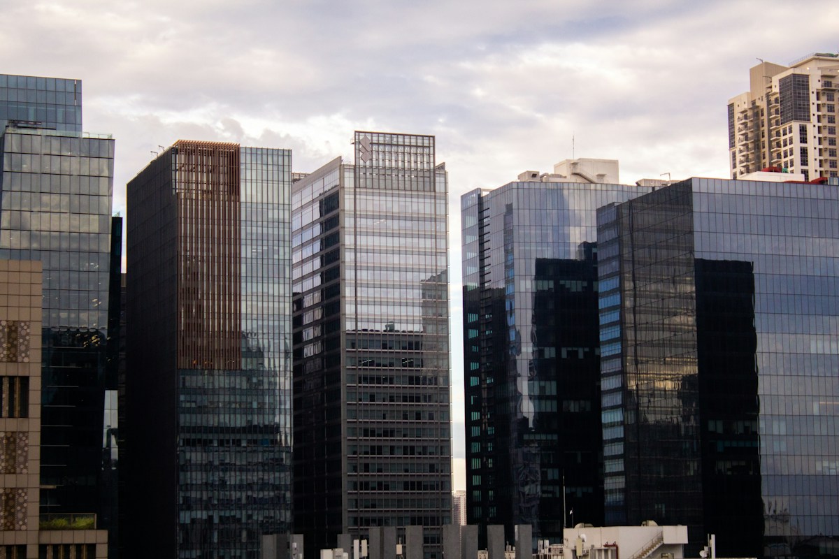 Modern glass office buildings against a cloudy sky in the Philippines