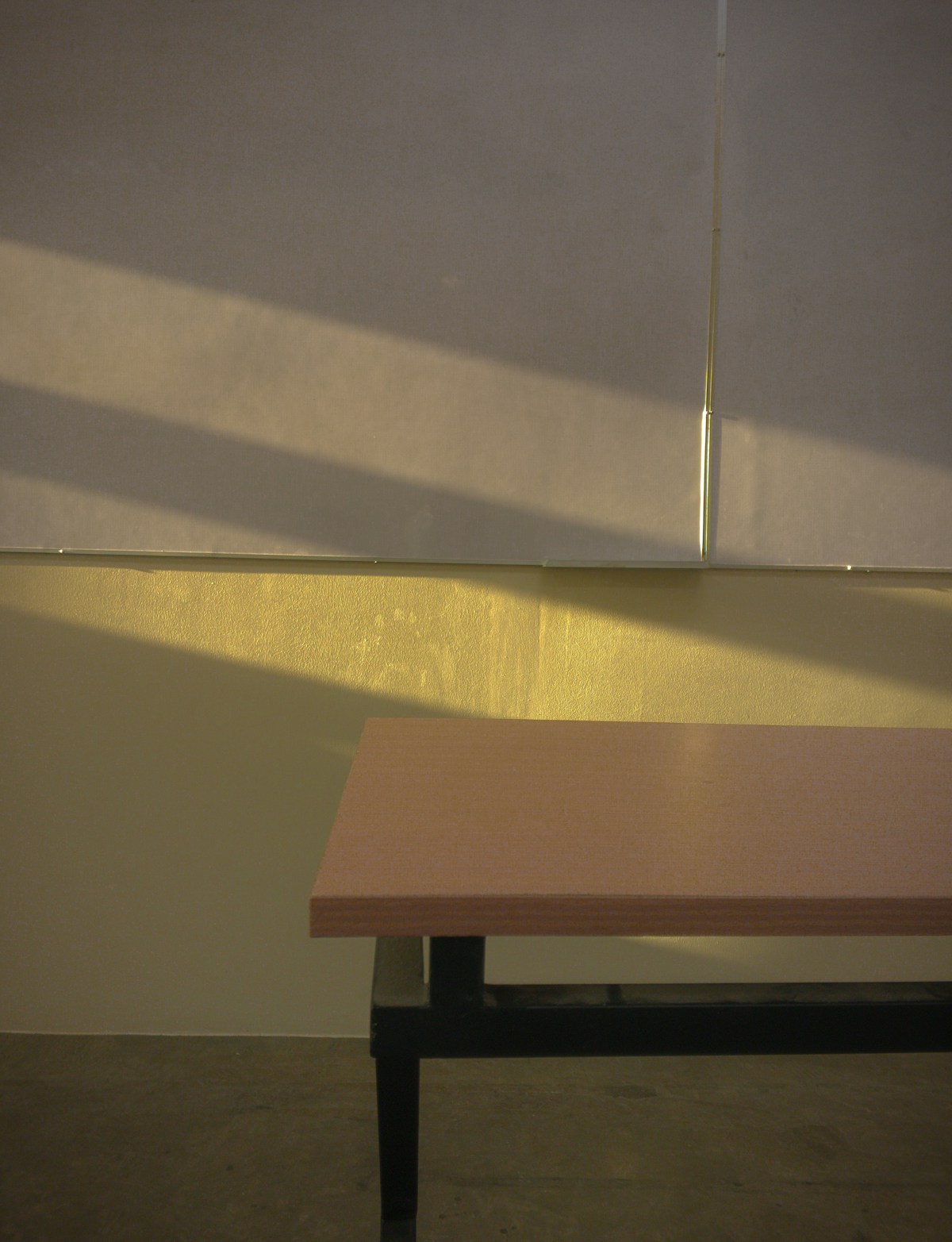 A wooden table sitting in front of a white wall in the Philippines