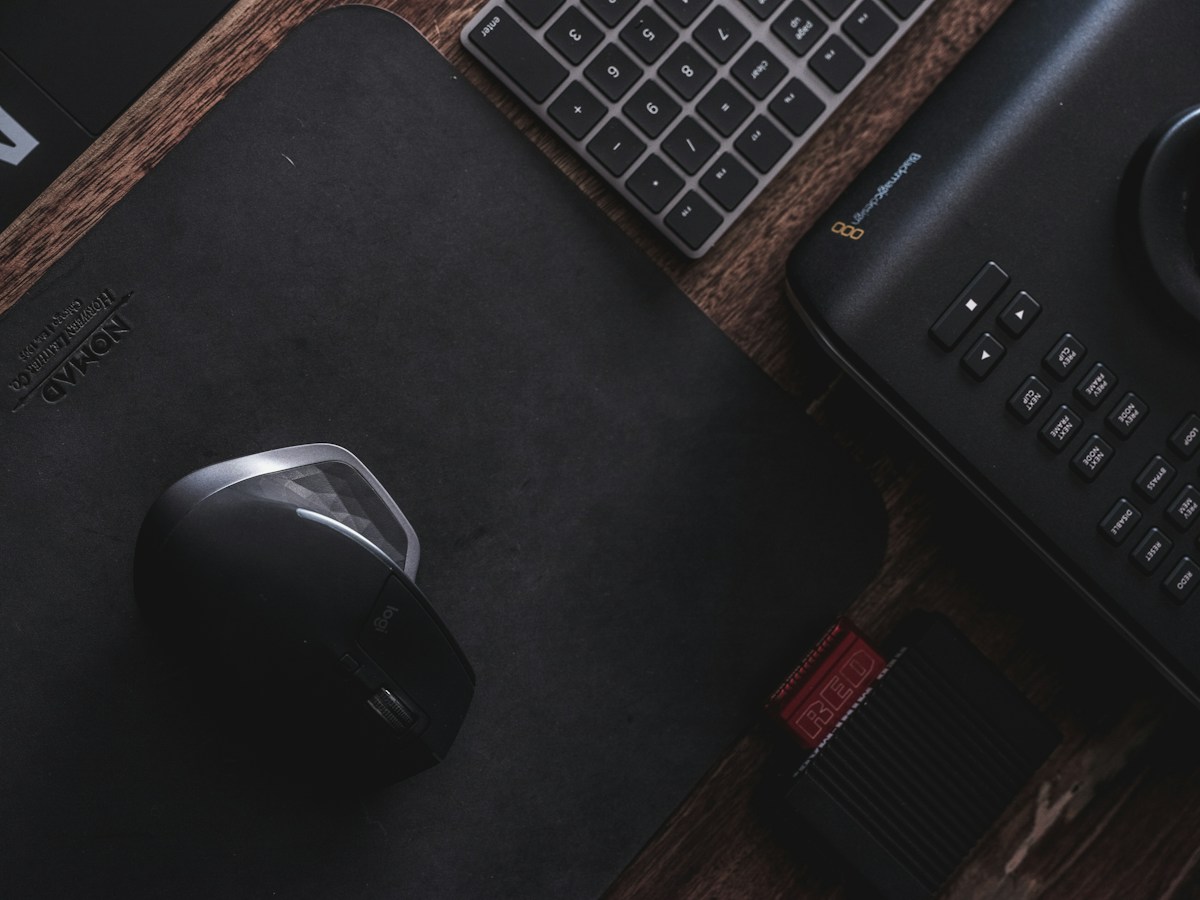 A mouse, keyboard, and mouse pad on a desk in the Philippines